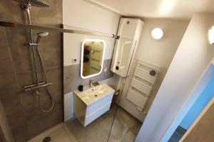 a bathroom with a sink and a shower at Night in the Heart of Torcy in Torcy