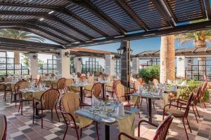 a restaurant with tables and chairs on a patio at Creta Royal - Adults Only in Skaleta