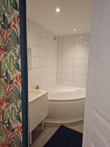 a bathroom with a tub and a toilet and a sink at Pause ton sac # Relais Saint Jacques #Venez dormir chez nous in Condom