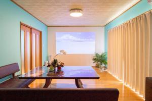 a living room with a table and a couch at Nagata House in Ise