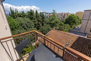 a balcony with a view of trees and buildings at Amasia Verona in Verona