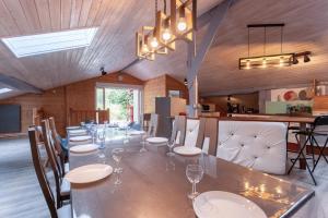 a large dining room with a long table and chairs at Villa À Isturits Avec Piscine in Isturits