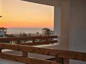 a balcony with a view of the beach at Résidences Nawal in Asilah