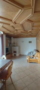 a bedroom with two beds and a wooden ceiling at Appartamenti Donatella in Cavalese