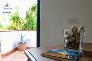 a vase filled with rocks on top of a table at B&b Biagio 2 Managed by Calabria Mare Experience in Cirella