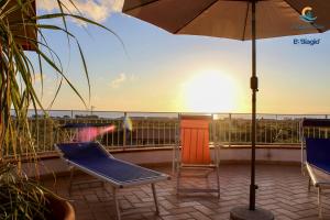 a balcony with two chairs and an umbrella at B&b Biagio 2 Managed by Calabria Mare Experience in Cirella
