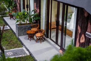 a patio with two chairs and a table at Cassowary Villas Sidemen by AGATA in Sidemen +16 photos