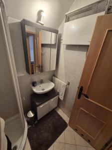 a small bathroom with a sink and a mirror at Marjetica 40 in Moravske-Toplice +30 photos