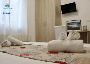 a room with a bed with towels on a table at B&b Biagio 2 Managed by Calabria Mare Experience in Cirella