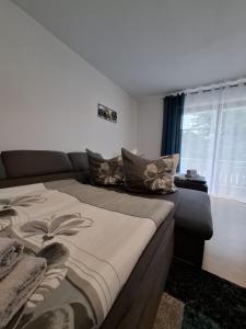 a bedroom with a large bed and a window at Ferienwohnung mit Balkon in Schwandorf in Bayern