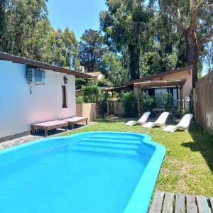 a swimming pool in the backyard of a house at Cabañas del Gordo in Mar del Plata