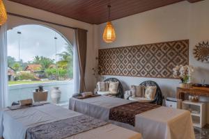 two beds in a room with a large window at Casa Maddu in Tegalalang +257 photos