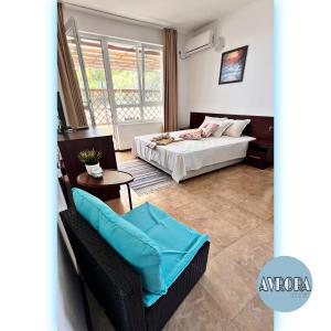 a bedroom with a bed and a chair in a room at Avrora Studio's in Byala +16 photos