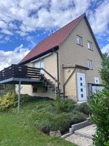 a house with a staircase on the side of it at Ferienhaus Glückszeit bei Goslar in Langelsheim