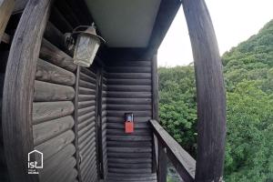 a wooden cabin with a red box on the side at IST Villa 05 Mountain Hideout in Wada