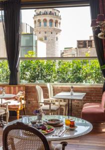 a room with a table and chairs and a tower at Meroddi Pera Flats in Istanbul