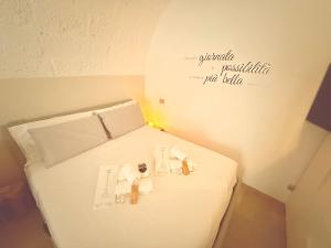 a small room with a bed with white sheets at Suite Salgemma in Polignano a Mare