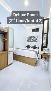 a bedroom with a bed and a sign that reads believe room floor at Laswi Syariah Guest House in Bandung