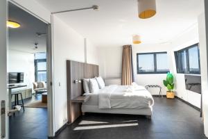 a hotel room with a bed and a desk at Poort Beach Boutique Apartments in Bloemendaal Aan Zee +150 photos
