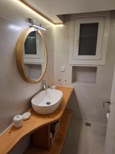 a bathroom with a sink and a mirror at Villa Manesi in Kithnos