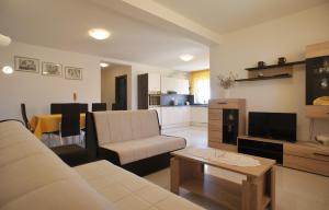a living room with a couch and a table at Spacious apartment sleeps 4 by the beach in Medulin
