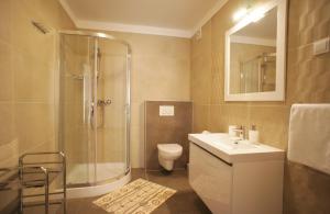 a bathroom with a shower and a toilet and a sink at Spacious apartment sleeps 4 by the beach in Medulin +34 photos