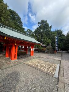 an orange building with a sign in front of it at ゲストハウス樹 in Shingū