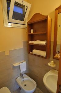 a bathroom with a sink and a toilet and a mirror at Blue Marine Village in Rodi Garganico +60 photos