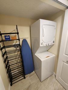 a small room with a refrigerator and a tv at Family Fun Getaway close to Disney in Kissimmee