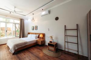 a bedroom with a large bed and a window at Twin Villa Zulia by Zanzibar Stays - Private Pool Villa Jambiani in Jambiani +59 photos