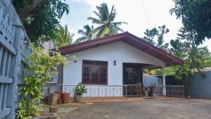 a white house with a red roof at The Misty in Dambulla in Dambulla