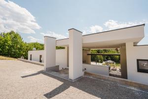 a rendering of a building with the letter h on it at Villa Alma Nova in Laktaši