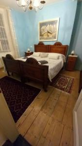 a bedroom with a bed in a blue room at Agritur Tenno Bio Natura in Tenno