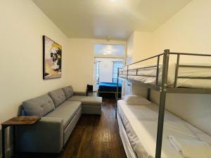 a living room with a bunk bed and a couch at The Manhattan on 48th in New York