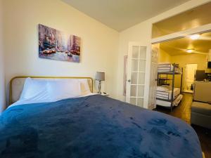 a bedroom with a large blue bed with a painting on the wall at The Manhattan on 48th in New York +11 photos