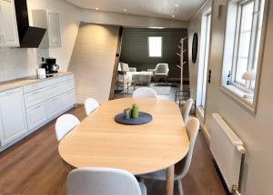 a kitchen and dining room with a wooden table and chairs at Newly renovated 2 bedroom apartment in Visby