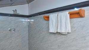 a bathroom with two white towels on a towel rack at The Misty in Dambulla in Dambulla +47 photos