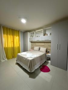 a bedroom with a large bed and a red rug at Nossa Casa de férias em Alter do Chão in Alter do Chao