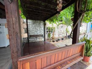 an open porch with potted plants and a stone wall at Nossa Casa de férias em Alter do Chão in Alter do Chao