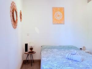 a bedroom with a bed with a blue comforter at Le Nid Urbain in Bourg-lès-Valence