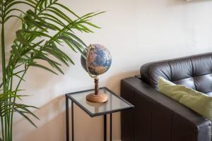 a globe on a glass table next to a couch at L'Astrolabe - superbe appartement vue Cathédrale in Rouen