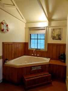 a large bath tub in a room with a window at Kalimna Woods Cottages in Lakes Entrance +138 photos