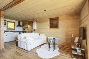 a living room with a white couch and a table at Chalet Sophie - Proche station de ski in Les Angles