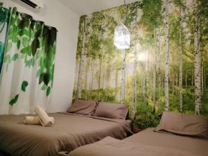 a room with two beds and a wall with trees at Sekinchan PaddyCruise Homestay Wifi in Sekincan +28 photos