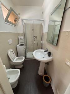 a bathroom with a toilet and a sink and a shower at Appartamento flowers&sea in Ventimiglia