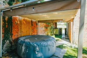 a cover over a barrel in a backyard at Cliveden Garden Cottage sleeps 6 - With Hot Tub, Parking, in Taplow - next to Cliveden National Park in Maidenhead