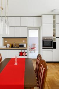 a kitchen with a table with a red napkin on it at Million Star Apartment in Budva