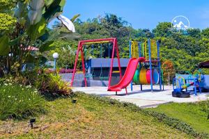 a playground with a colorful slide in a park at Terrace Garden Glamping Bogor in Gadog
