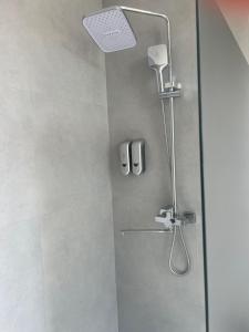 a shower in a bathroom with a glass door at Osh Art Hotel in Osh +33 photos