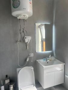 a bathroom with a white toilet and a sink at Osh Art Hotel in Osh +33 photos